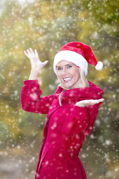 Woman with Santa hat enjoying first snow — Stock Photo, Image