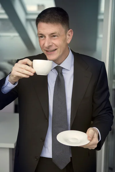 Man in suit holding a cup — Stock Photo, Image