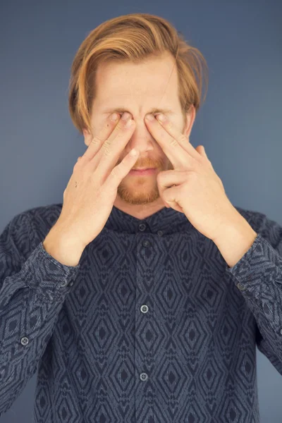 Portrait of red-haired young man with a headache — Stock Photo, Image