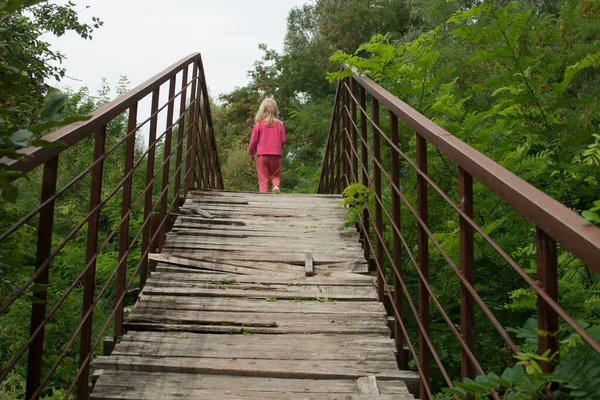Маленькая Девочка Идет Старому Деревянному Мосту — стоковое фото