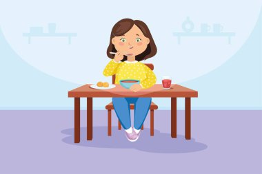 Kız masada oturarak yemek yiyor.