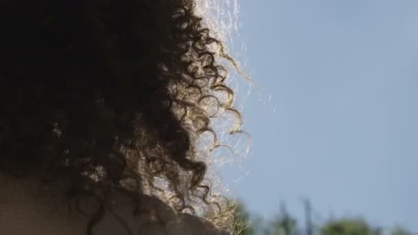 Main féminine touchant le ciel bleu et se levant au soleil .