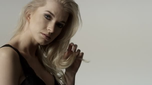 Portrait of a beautiful sexy blonde woman wearing black underwear. — Stock Video