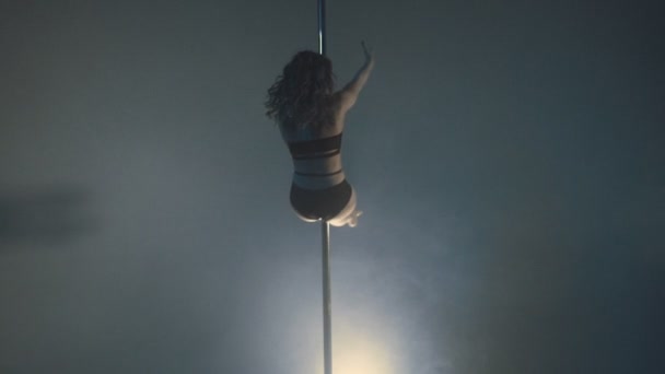 Young slim sexy blonde pole dance woman exercising in studio. — Stock Video