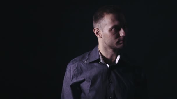 Portrait of handsome young man on a black background. — Stock Video