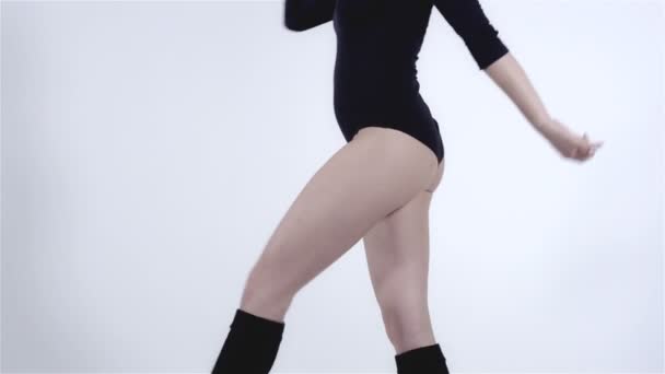 Legs of a modern dancer with black body costume wearing knee-highs.