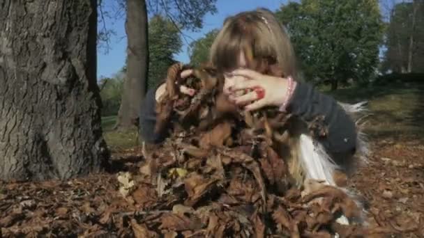 Meisje buiten spelen in herfst park. — Stockvideo