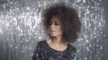 Genç güzel Afro-Amerikan kız kameraya bakarak zarif elbise poz