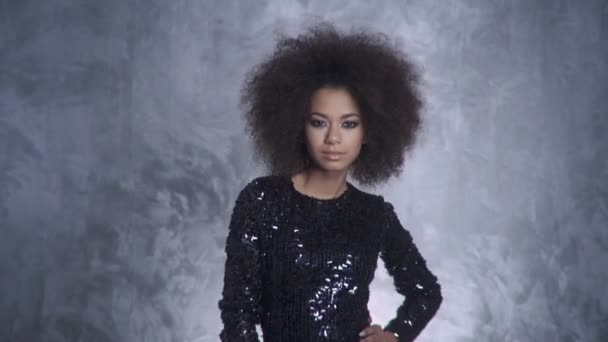 Young stylish woman with afro holding sparklers and smiling to a camera. — Stock Video