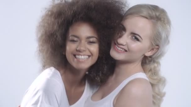 Deux petites amies heureuses posant sur fond blanc . — Video