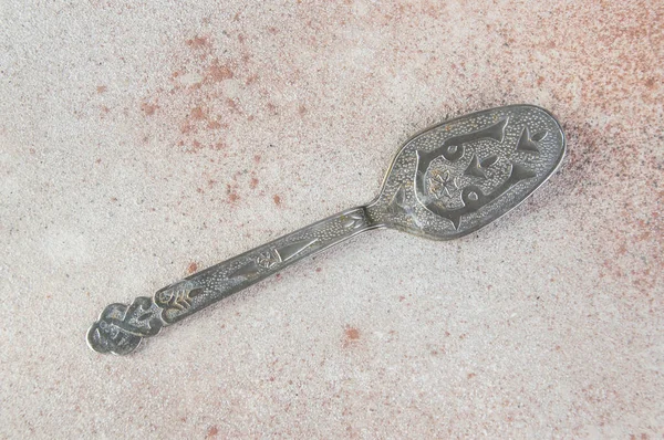 Old metal cake spatula on concrete background. Food photography props