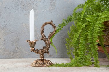 Beton zeminde bir mum için antik pirinç şamdan. Metin için alanı kopyala. 