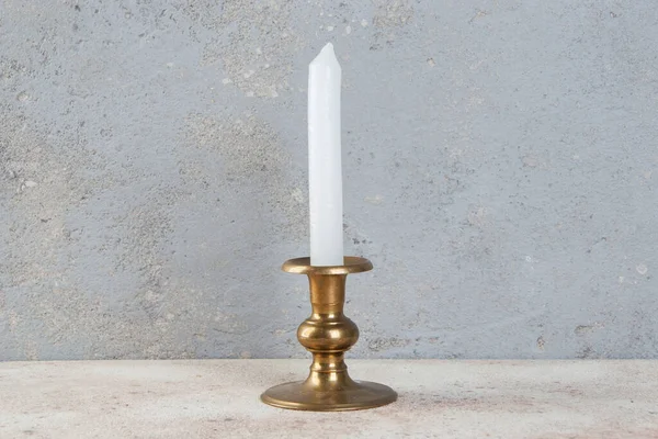 Beton zeminde bir mum için antik pirinç şamdan. Metin için alanı kopyala. 