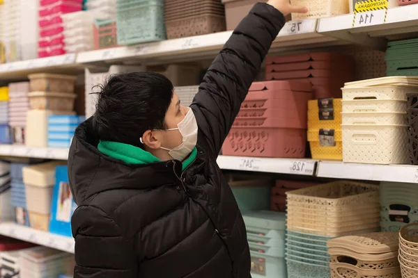 Una Mujer Con Máscara Elige Cosas —  Fotos de Stock