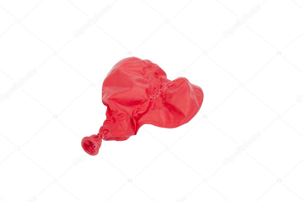 Popped red heart shaped balloon isolated on white