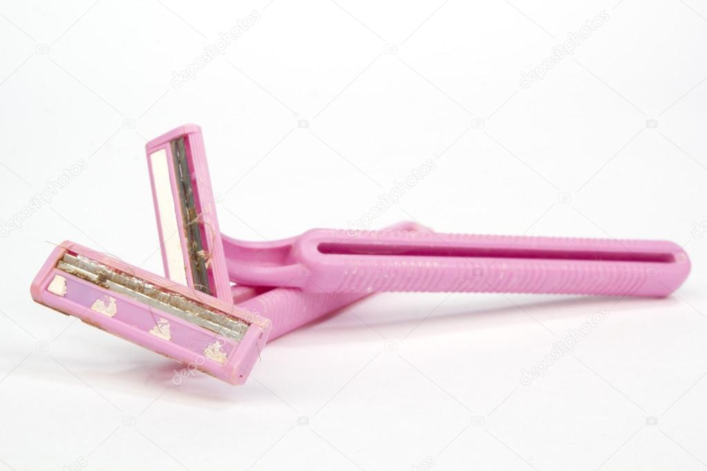 Pair of pink well used dirty old safety razors isolated on white