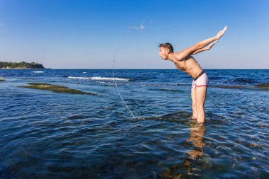 Denizden çıkan çıplak genç adam