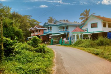 Goa, India - October 24, 2018: A portuguese style house built on a corner of a road against clear blue sky. Portugal architecture in Goa.