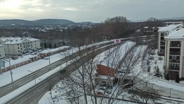 波兰克拉科夫 Krakow 一架无人驾驶航空器拍摄了一条被积雪覆盖的公路 车上的车辆在冬季经过 — 图库视频影像