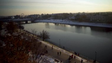 Krakow, Güney Polonya - 31 Ocak 2021: Vistula Nehri 'nin insansız hava aracı görüntüleri ve hafta sonu yürüyüş yapan ve şehir merkezinde boş zaman geçiren insanlar. Kışın kırılan şehir manzarası.
