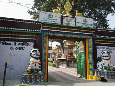 Varanasi, Hindistan - 01 Kasım 2016: Sarnath Tibet Budist Manastırı 'nın Ağaç Altında Buda heykeli ile giriş kapısı