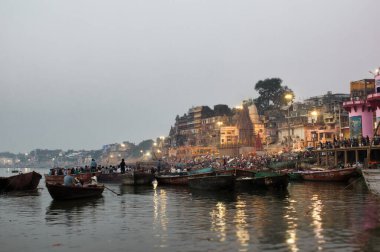 Varanasi, Hindistan - 01 Kasım 2016: Varanasi 'de ya da eski Banaras kenti Hindistan' da Banaras Ghat Aarti 'de Banaras Nehri' nde Ganga Nehri Akşamı 'nda Antik Ahşap Ghat Gecesi' nde düzenlenen törende, eski Hindu tapınaklarının kutsal ghatlarındaki Ganga Nehri 'ndeki botlar 