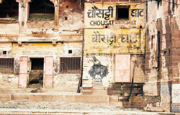 Varanasi, India - November 01, 2016: Chausati ghat graffiti written on rusty old wall showing ancient hindu culture in a famous landmark in Banaras in the state of Uttar pradesh.