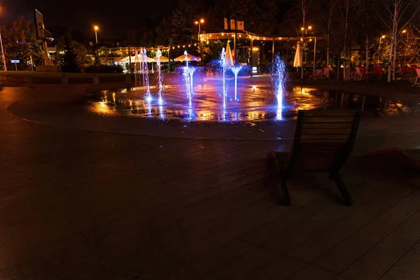 Een Lege Stoel Tegenover Kleurrijke Fonteinen Tijdens Nacht Kazimierz Krakau — Stockfoto