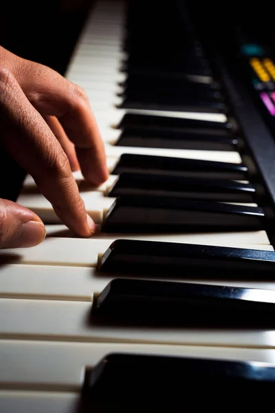 Close Up Of a human or person fingers or hand Playing Piano. Man playing musical instrument concept.