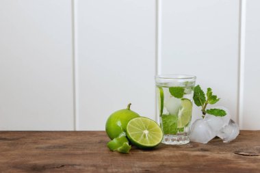 Votka soğuk kokteyl limonu. Kuzu eti, buz, nane yaprağı ve ahşap masada limon..