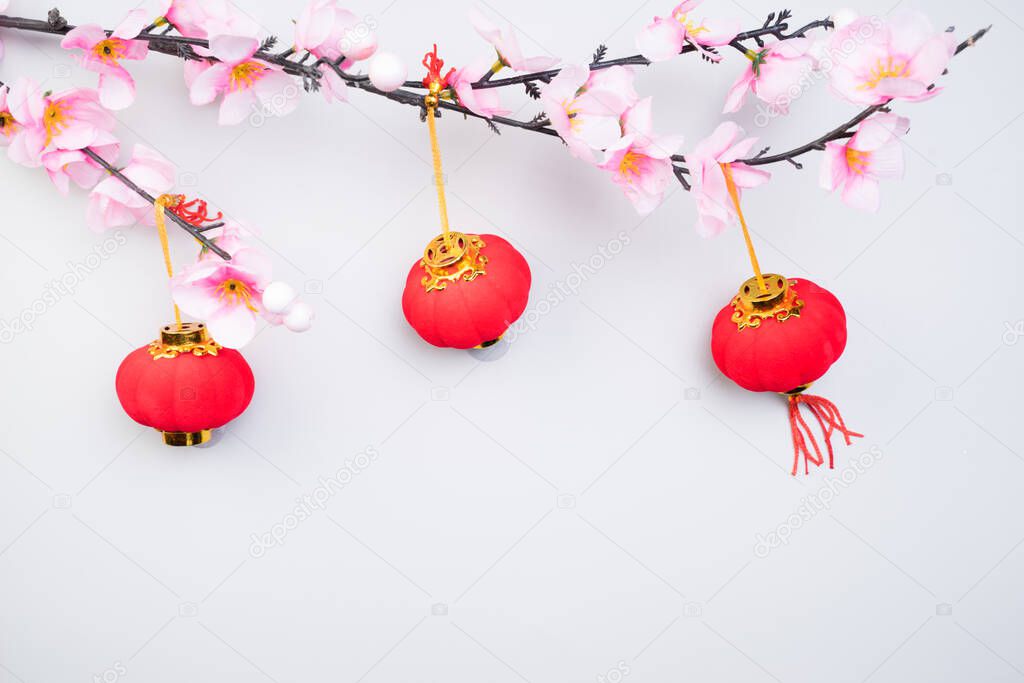 Chinese New Year design with cherry blossom and red lanterns on light grey background