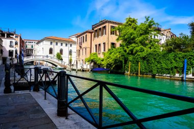 Venedik 'te küçük dar kanallar, botlar ve İtalya' daki köprülerin altında yüzen gondollarla dolu güzel bir gün..