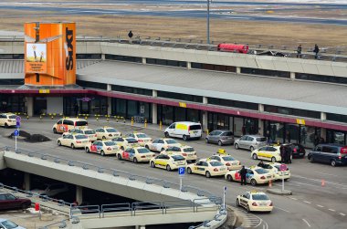 Line of yellow taxi cabs waiting for passengers outside Tegel Airport in Berlin. Berlin, Germany clipart