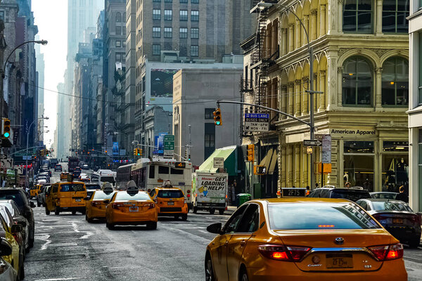 Broadway in New York City with yellow New York City taxi cabs on the streets. Manhattan, New York.