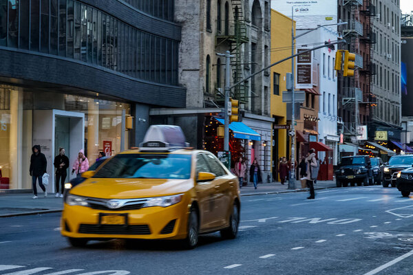SoHo neighborhood in New York City Manhattan with yellow New York City taxi cabs on the streets. Manhattan, New York.