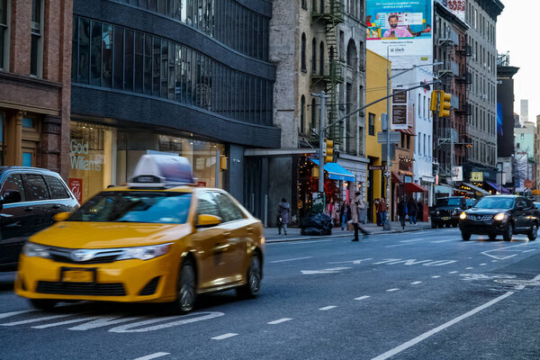 New York City SoHo neighborhood in Manhattan with yellow New York City taxi cabs on the streets. Manhattan, New York.