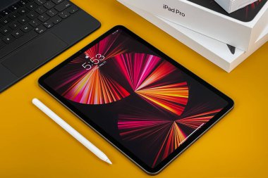 iPad Pro 11-inch 2021 model with Apple M1 chip on a desk with Magic keyboard and Apple pencil. New York, NY, USA May 21, 2021.