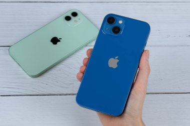 iPhone 13 mavi ve iPhone 12 yeşil. 