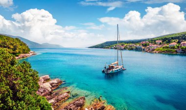 Marvelous summer view of Fiskardo port. Stunning morning seascape of Ionian Sea. Picturesque morning scene of Kefalonia island, Greece, Europe. Traveling concept background clipart