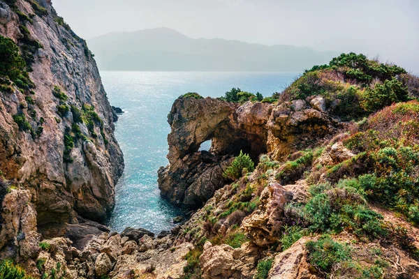 Misty spring view of Pirates Bay, Porto Timoni, Afionas village location. Great morning seascape of Ionian Sea. Colorful outdoor scene of Corfu island, Greece, Europe. Beauty of nature concept background