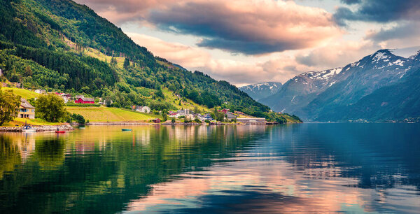 Splendid summer sunrise in Lofthus village in Ullensvang municipality which is located in the Hardanger region of Hordaland county, Norway. Beauty of countryside concept background.