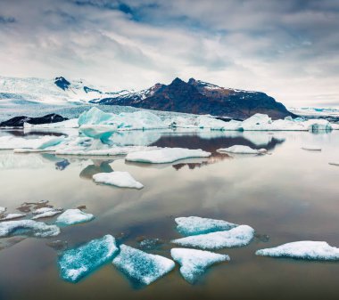 Fjallsarlon buzul gölünde yüzen buz kutusu. Vatnajokull Ulusal Parkı, Güneydoğu İzlanda, Avrupa 'da dondurucu bir yaz sabahı. İşlenmiş fotoğraf sonrası sanatsal stil.