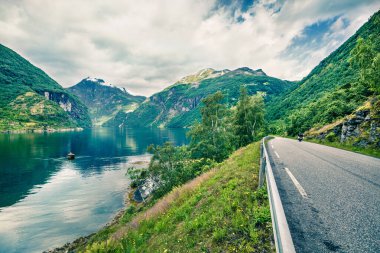 Sunnylvsfjorden fiyordunun kıyısında motosiklet sürmek. Batı Norveç, Avrupa 'nın renkli sabah manzarası. Seyahat konsepti geçmişi. Instagram filtre tonu.