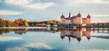 Exciting morning panorama of Moritzburg Baroque palace surrounded by a lake. Great autumn sunrise in Saxony, Dresden location, Germany, Europe. Traveling concept background. clipart