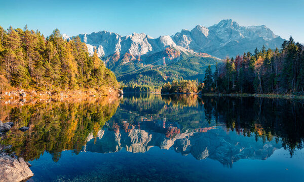 Bright evening scene of Eibsee lake with Zugspitze mountain range on background. Beautifel autumn view of Bavarian Alps, Germany, Europe. Beauty of nature concept background