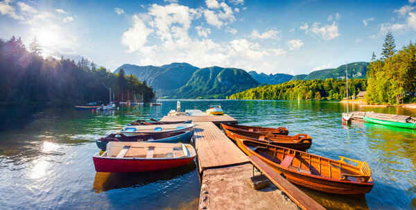 Colorful summer panorama of the Bohinj Lake. Picturesque moning scene in the Triglav National Park, Julian Alps, Slovenia. Popular tourist leisure on the boat. Artistic style post processed photo