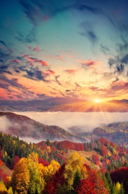 sunset in the foggy mountains. clipart