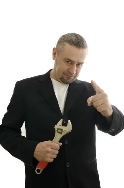 Encanador em uma jaqueta com uma chave na mão — Fotografia de Stock