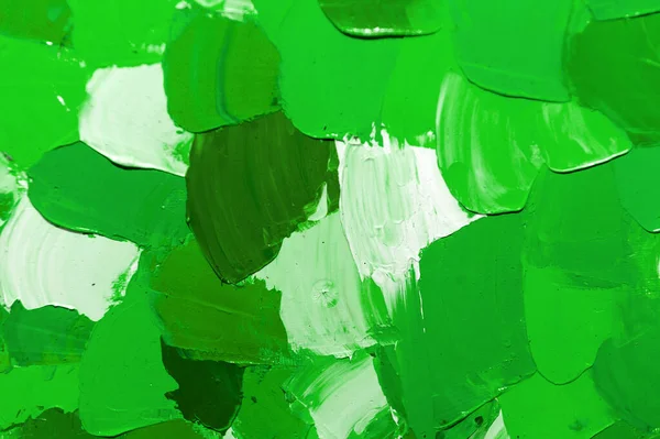 Green background from smeared paints on canvas. St.Patrick \'s Day. Green contrast background of oil paints