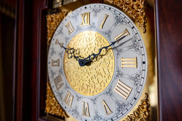 Dial of a vintage grandfather clock. Antique grandfather clock face. 